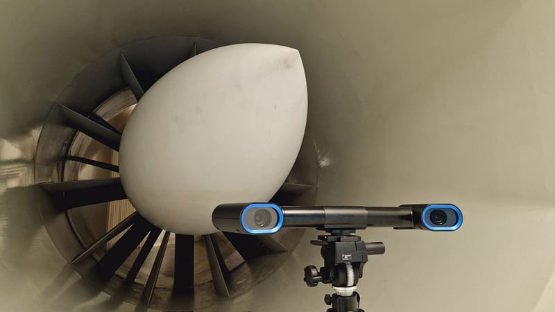 MobiusWT is stood on a tripod in front of a wind tunnel